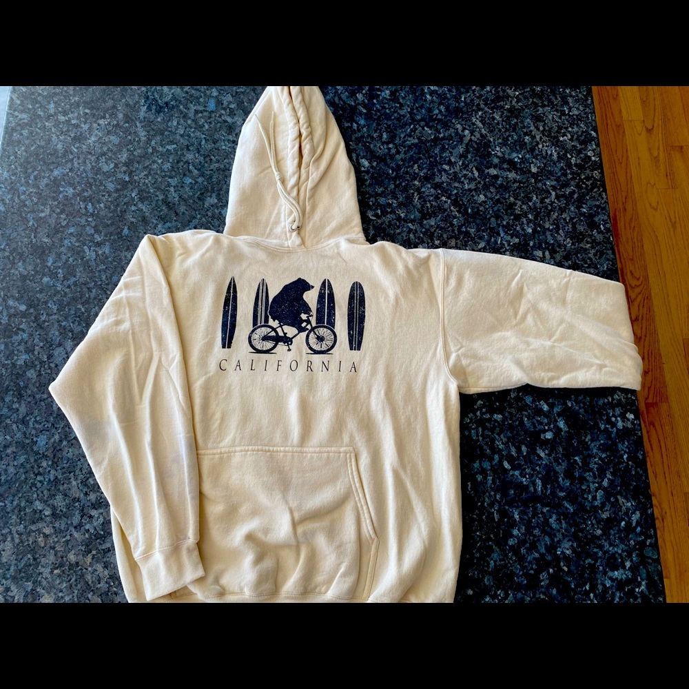 Pale yellow sweatshirt from California shop. With surf boards and bear.